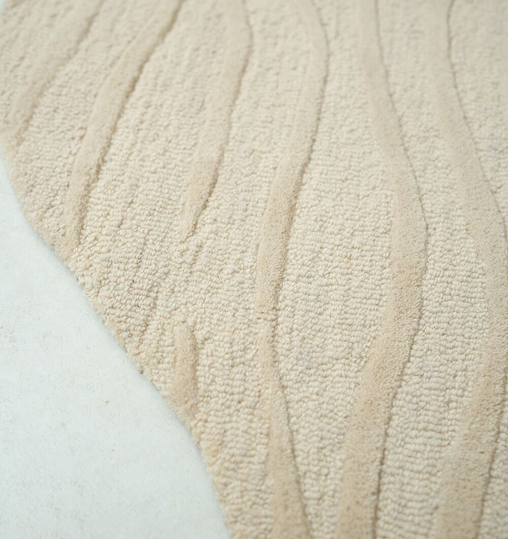 Bespoke custom wool rug with intricate floral motifs in soft neutral colors by Ramsha Carpets