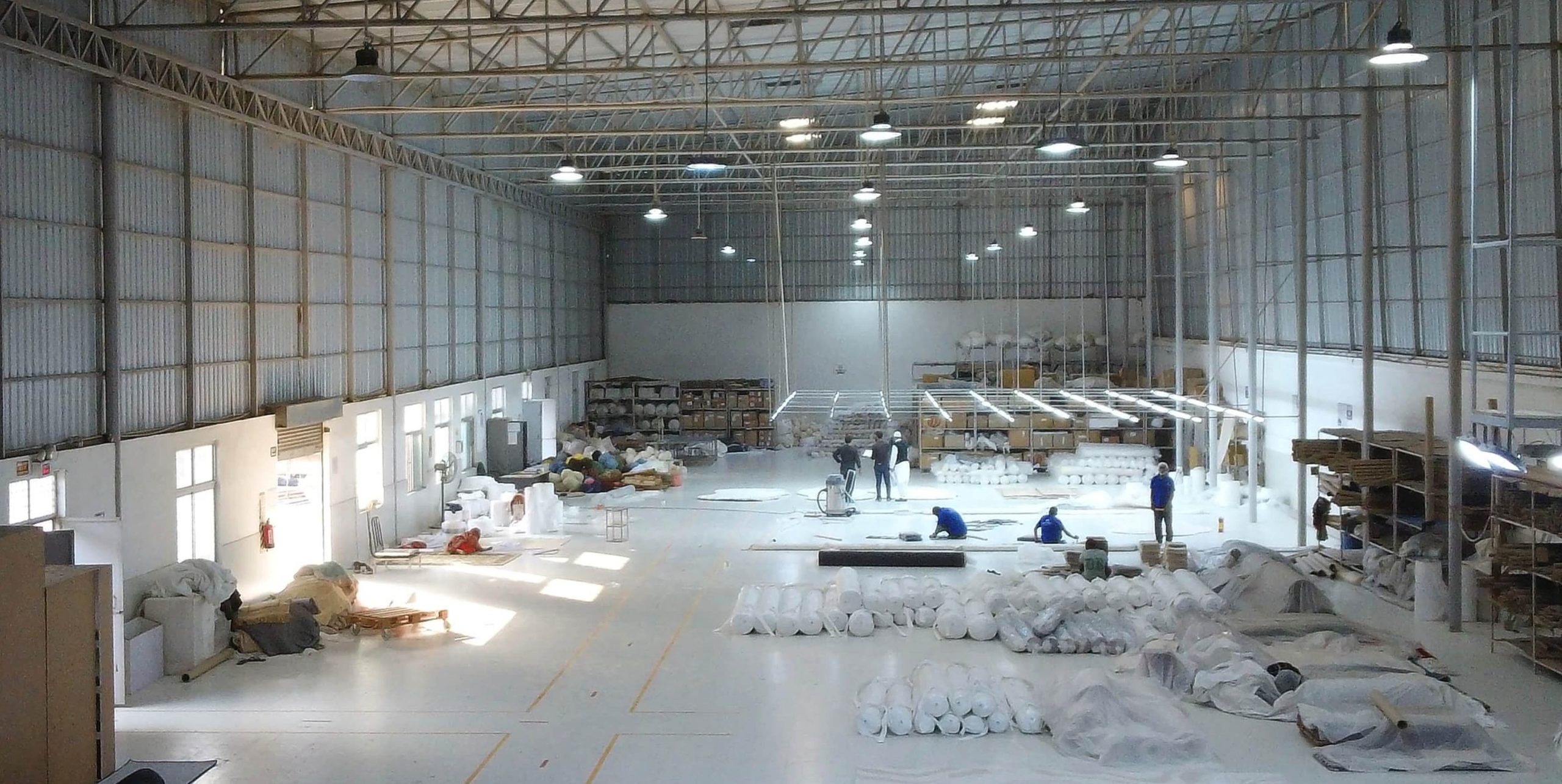 Ramsha Carpets manufacturing hall showing skilled workers crafting customised rugs and carpets