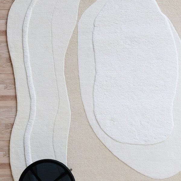 Custom minimalist rug in neutral tones, handcrafted by Ramsha Carpets for modern interior styling.