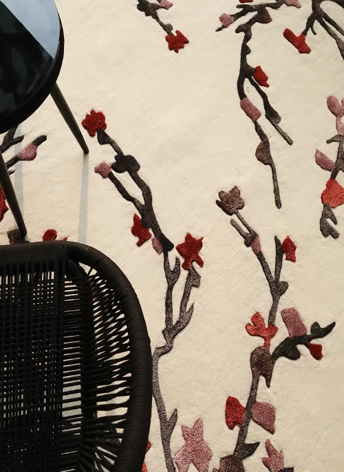 Custom rug with an unconventional geometric shape, laid in a designer lounge area by Ramsha Carpets