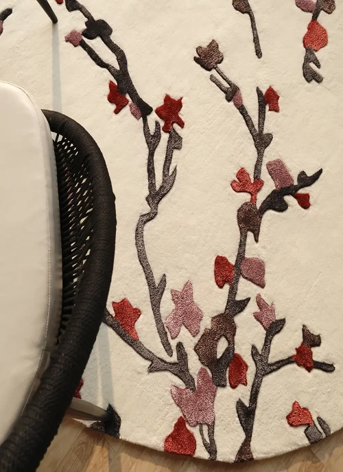 Custom rug with an unconventional geometric shape, laid in a designer lounge area by Ramsha Carpets