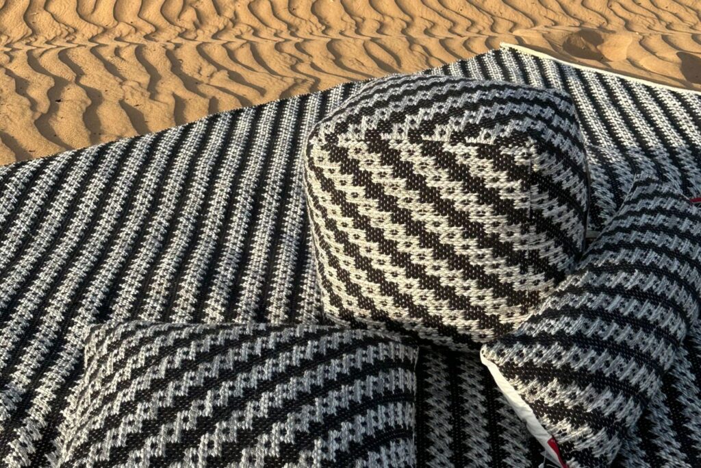 Custom rug with a corporate logo in a hotel reception area, made by Ramsha Carpets