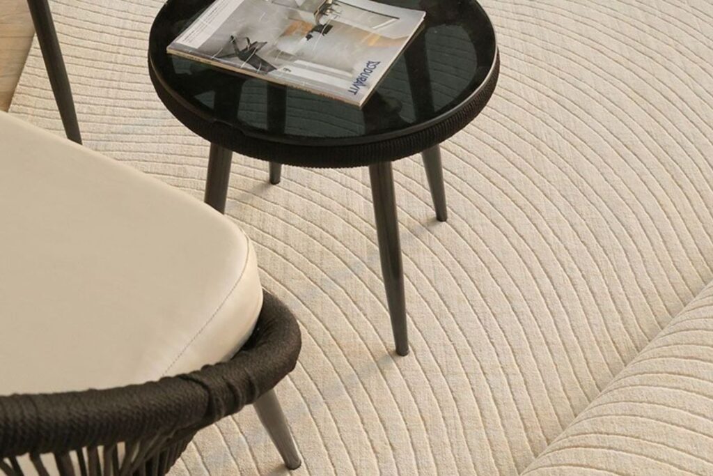 Elegant custom carpet installed in a luxury living room, designed by Ramsha Carpets