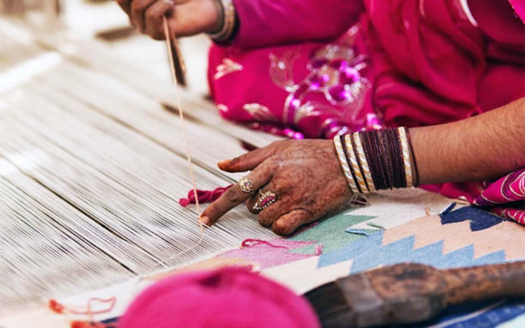 Custom rug with a corporate logo in a hotel reception area, made by Ramsha Carpets