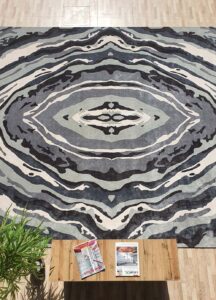 Selection of color poms and size templates used to create custom rugs at Ramsha Carpets
