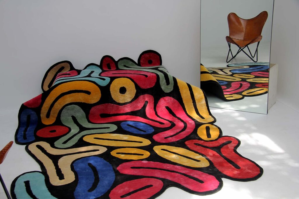 Custom rug with a corporate logo in a hotel reception area, made by Ramsha Carpets