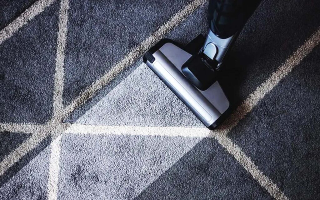 Skilled artisan hand-tufting a custom rug at Ramsha Carpets' production facility