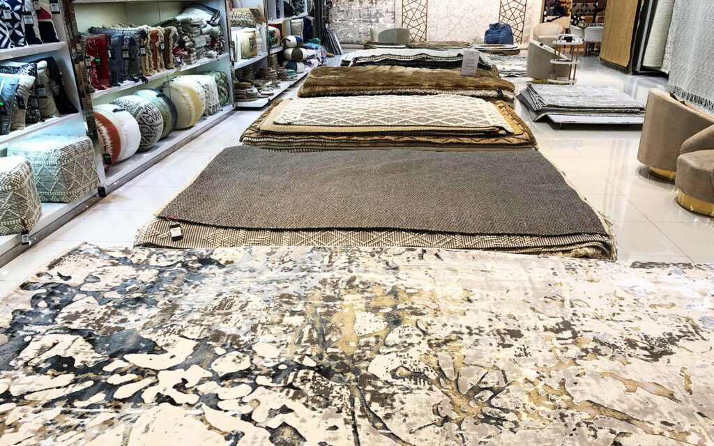Selection of color poms and size templates used to create custom rugs at Ramsha Carpets