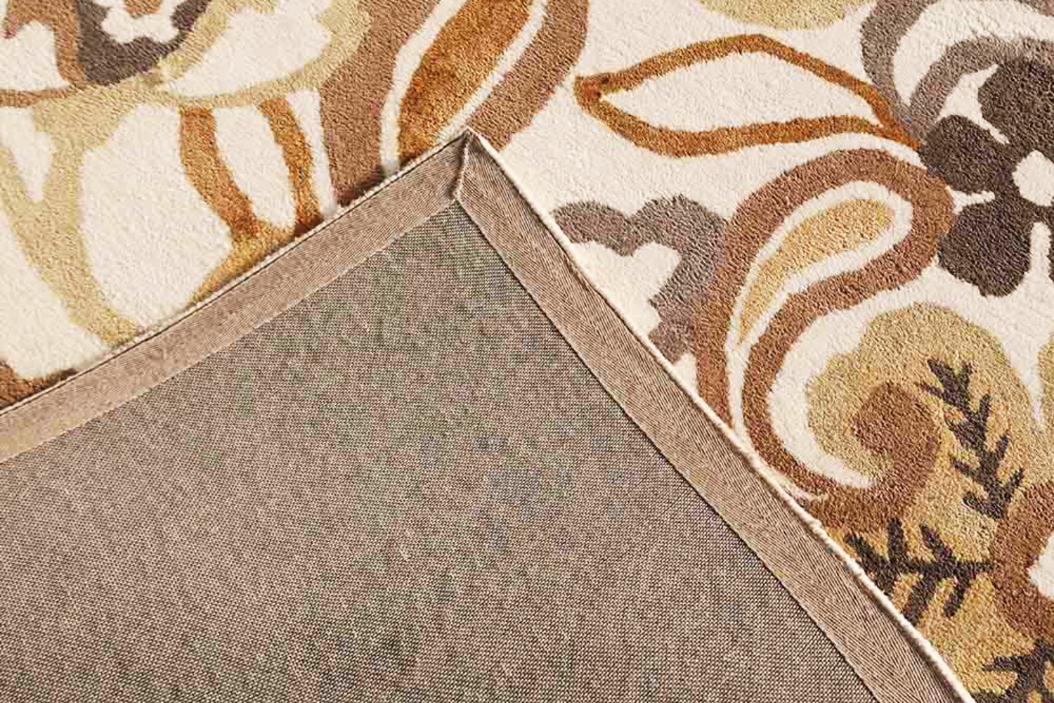 A professional technician performing carpet stretching and repairing on a buckled living room carpet to remove ripples.